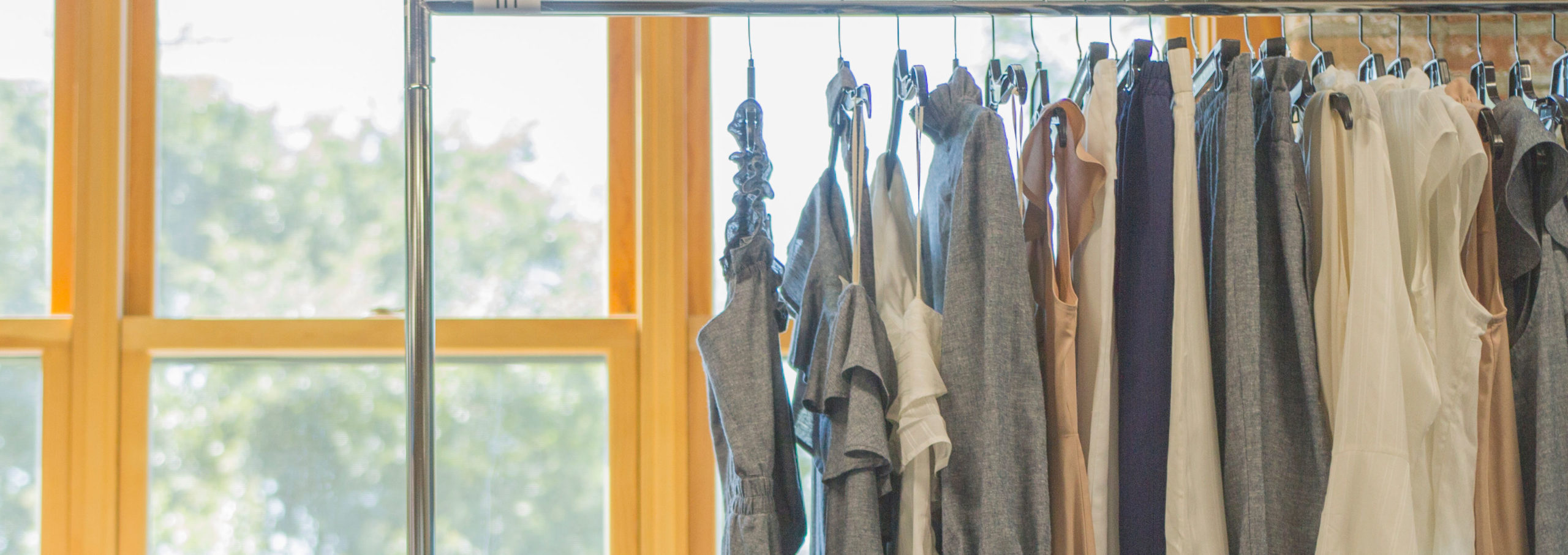 finished clothes on a clothing rack in the apparel agency studio